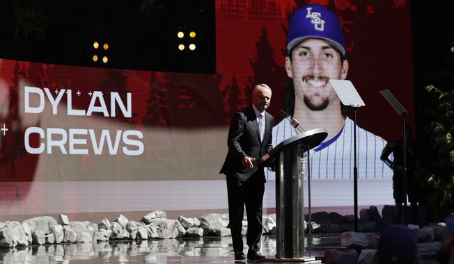 Commissioner Robert D. Manfred announces the pick of Dylan Crews by the Washington Nationals in baseball&#x27;s amateur draft, Sunday, July 9, 2023, in Seattle. (AP Photo/John Froschauer)