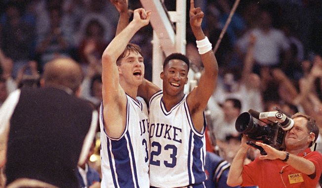 Duke University Blue Devils Christian Laettner, left, and Brian Davis raise their arms in victory following their NCAA Semifinal win over Arkansas Saturday, March 31, 1990, 97-83, in Denver. Duke will advance to the Championship game Monday. (AP Photo/Eric Risberg) **FILE**