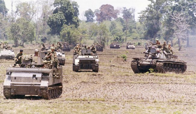 United States armored unit moves north into Cambodia, 10 miles north of Katum base in South Vietnam. Unit is 2/47 Infantry, A-Company, the first to cross the border into Cambodia on May 1, 1970, following orders from U.S. President Richard Nixon to search out Communist High Command Headquarters. (AP Photo/Henri Huet) ** FILE **
