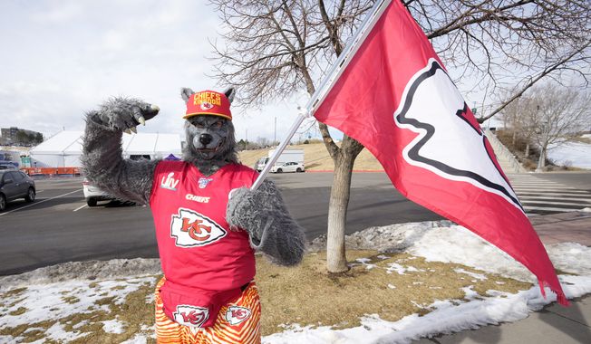 A Kansas City Chiefs fan, Chiefsaholic, poses for photos while walking toward Empower Field at Mile High before an NFL football game between the Denver Broncos and the Chiefs Saturday, Jan. 8, 2022, in Denver. (AP Photo/David Zalubowski) **FILE**