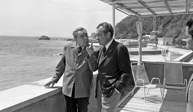 Soviet Communist party leader Leonid Brezhnev makes a point to U.S. President Richard Nixon during a walk through the grounds of Brezhnev&#x27;s dacha on the Black Sea in Yalta, June 30, 1974. (AP Photo)