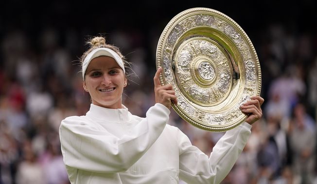 Czech Republic&#x27;s Marketa Vondrousova celebrates with the trophy after beating Tunisia&#x27;s Ons Jabeur to win the final of the women&#x27;s singles on day thirteen of the Wimbledon tennis championships in London, Saturday, July 15, 2023. (AP Photo/Alberto Pezzali)