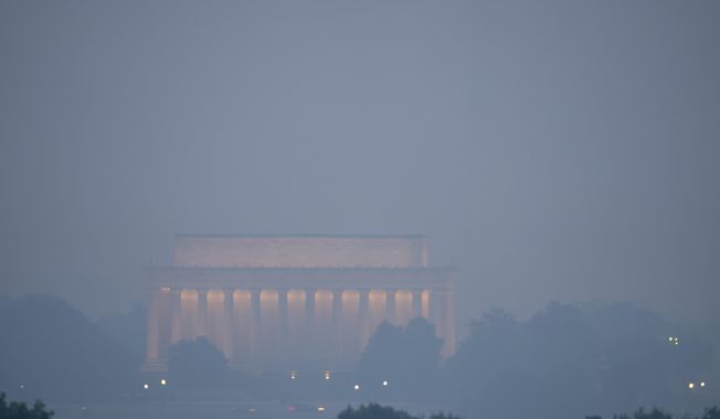 Haze blankets the Lincoln Memorial on the National Mall in Washington, Thursday, June 8, 2023, as seen from Arlington, Va. Smoke from Canadian wildfires is pouring into the U.S. East Coast and Midwest and covering the capitals of both nations in an unhealthy haze. (AP Photo/Alex Brandon)