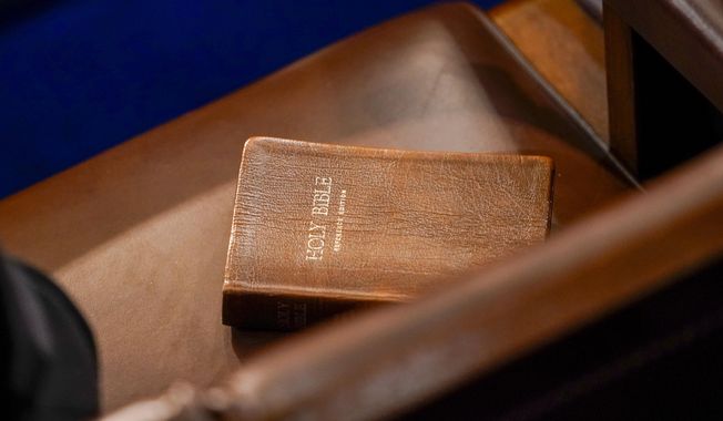 FILE - A Bible is seen on a chair in the House chamber in Washington, Jan. 6, 2023. The Bible will return to the shelves in a northern Utah school district that provoked an outcry after it banned them from middle and elementary schools. The Davis School District said in a statement on Tuesday, June 20, that its board had determined the sacred text was age-appropriate for all school libraries. (AP Photo/Andrew Harnik, File)