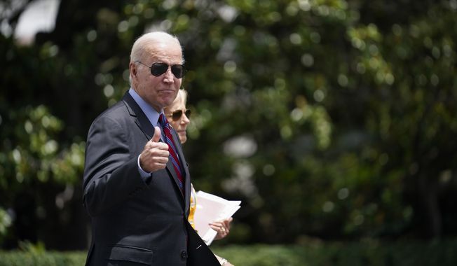 President Joe Biden gives a thumbs up as he walks with first lady Jill Biden to board Marine One on the South Lawn of the White House in Washington, Friday, July 14, 2023, as they head to Camp David for the weekend. (AP Photo/Stephanie Scarbrough)