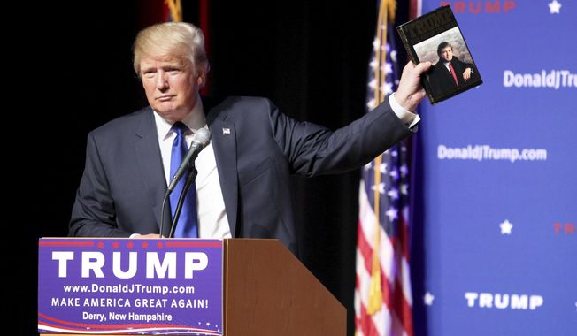 In this Aug. 19, 2015, file photo, Republican presidential candidate Donald Trump holds up a copy of his 1987 book, &amp;quot;Trump: The Art of the Deal&amp;quot; during his campaign town hall event at Pinkerton Academy in Derry, N.H. (AP Photo/Mary Schwalm, File)