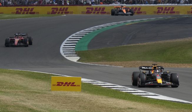 Red Bull driver Max Verstappen of the Netherlands, right, steers his car during the qualifying session at the British Formula One Grand Prix at the Silverstone racetrack, Silverstone, England, Saturday, July 8, 2023. The British Formula One Grand Prix will be held on Sunday. (AP Photo/Luca Bruno)