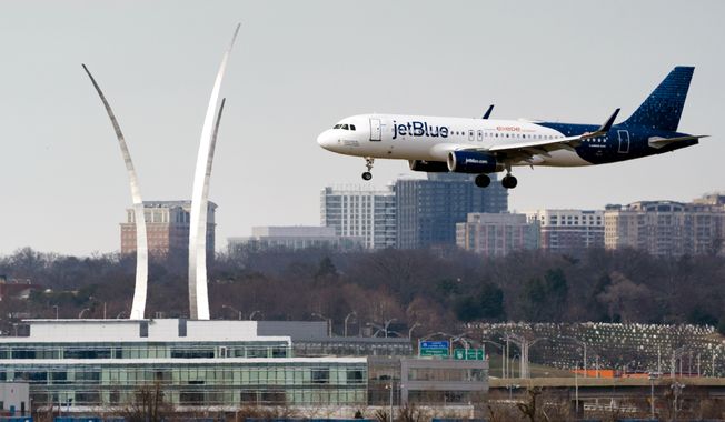A JetBlue passenger flight lands at Reagan Washington National Airport in Arlington, Va., across the Potomac River from Washington, Wed., Jan. 19, 2022. Transportation Secretary Pete Buttigieg said Sunday that the blame leveled at the Federal Aviation Administration by airline companies over flight cancellations around the busy July Fourth holiday is misplaced. (AP Photo/J. Scott Applewhite, File)