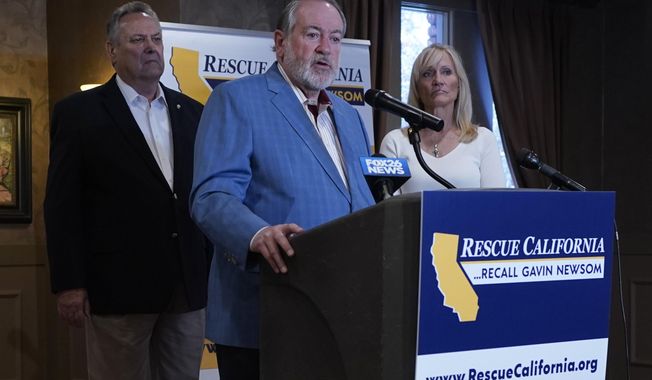 Former Arkansas Gov. Mike Huckabee, a Republican, speaks in support of the recall of Calif., Gov. Gavin Newsom Calif., Friday, July 30, 2021. Huckabee, flanked by former California Secretary of State Bill Jones, a Republican, and Anne Dunsmore, campaign manager of the pro-recall group Rescue California, attended a fund raising breakfast for the recall campaign. While Democratic registration almost doubles that of Republicans in the state, Democratic Party leaders fear Republicans appear more eager to vote in the Sept. 14 election. (AP Photo/Rich Pedroncelli))
