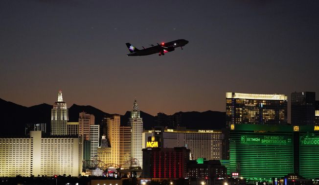 A plane takes off from Harry Reid International Airport near casinos along the Las Vegas Strip, Wednesday, Sept. 29, 2021, in Las Vegas. Nevada&#x27;s tourism economy is putting the coronavirus pandemic behind it, with regulators reporting the best casino winnings ever for a February and the airport serving Las Vegas announcing plans to resume nonstop international flights in April. The Nevada Gaming Control Board on Wednesday, March 30, 2022 reported a 12th straight month of $1 billion or more in casino house winnings, a key index of state economic health. The state reaped almost $59 million in casino taxes based on the figure, up more than 34% from a year ago. (AP Photo/John Locher, File)