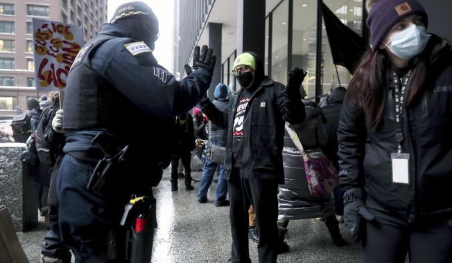 A Chicago police sergeant and a legal observer argue as protesters call for federal civil rights charges during a rally after former Chicago police officer Jason Van Dyke was released from prison, Thursday, Feb. 3, 2022, at Federal Plaza in Chicago. Former Chicago police Officer Jason Van Dyke left prison on Thursday after serving less than half of his nearly seven-year sentence for killing Black teenager Laquan McDonald, angering community leaders who feel the white officer&#x27;s punishment didn&#x27;t fit his crime. (John J. Kim/Chicago Tribune via AP) **FILE**