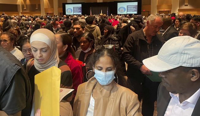 Hundreds of people become U.S. citizens during a naturalization ceremony at a convention center in Saint Paul, Minn., on March 9, 2023. The U.S. citizenship test is being updated and some immigrants and advocates worry the changes will hurt test-takers with lower levels of English proficiency. The test is one of the final steps toward citizenship — a months-long process that requires legal permanent residency for years before applying. (AP Photo/Trisha Ahmed)