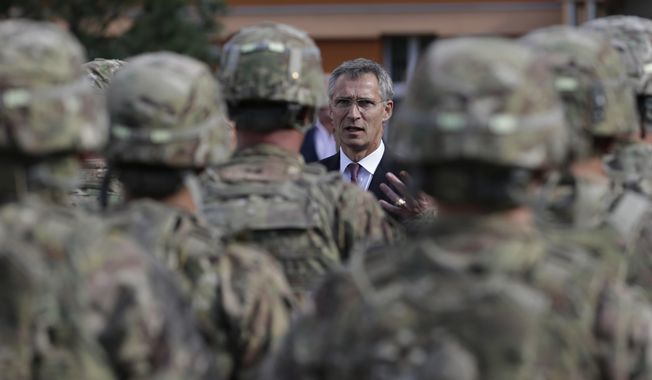 NATO Secretary General Jens Stoltenberg talks to US army soldiers while visiting Prague, Czech Republic, Wednesday, Sept. 9, 2015. On Wednesday July 19, 2023, Czech Parliament approved a defense treaty with the United States. The lower house of Parliament voted in favor of the Defense Cooperation Agreement that sets a legal framework for possible deployment of U.S. troops on Czech territory and their cooperation with the Czech armed forces. (AP Photo/Petr David Josek, File)