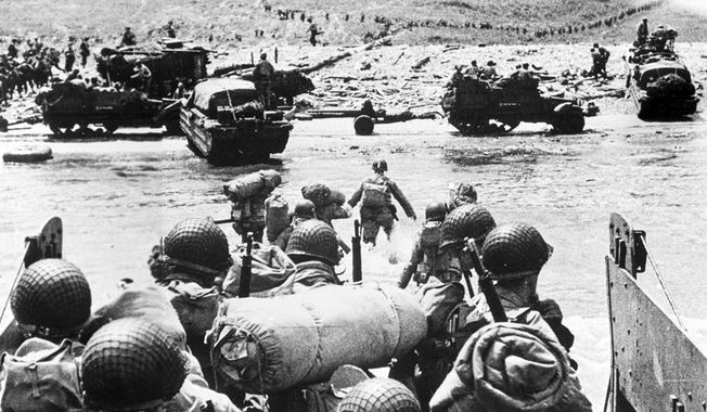 American soldiers and supplies arrive on the shore of the French coast of German-occupied Normandy during the Allied D-Day invasion on June 6, 1944 in World War II.   (AP Photo)