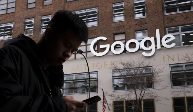 A man using a cellphone walks past Google offices on Dec. 17, 2018, in New York. Attorneys debated the proper jurisdiction for settling a legal challenge to the first-in-the-nation tax on digital advertising during arguments before Maryland&#x27;s highest court on Friday, May 5, 2023. Attorneys for Big Tech companies like Facebook, Google and Amazon have contended the law unfairly targets them. (AP Photo/Mark Lennihan) **FILE**