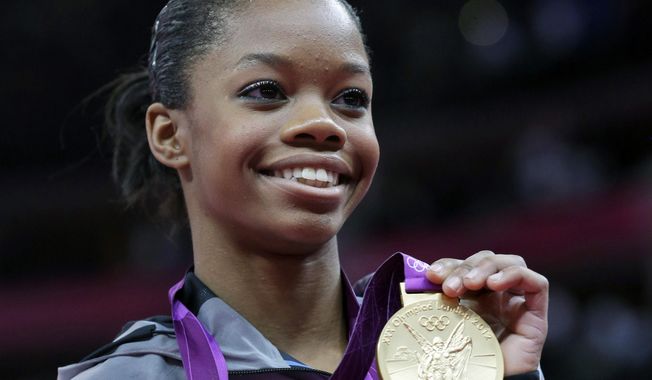 U.S. gymnast Gabby Douglas displays her gold medal during the artistic gymnastics women&#x27;s individual all-around competition at the 2012 Summer Olympics in London, Aug. 2, 2012. Douglas, the first Black woman to win the Olympic all-around gymnastics title, is taking aim at the 2024 Games in Paris. Douglas announced on her Instagram page Thursday, July 13, 2023, that she is making a comeback attempt, a dozen years after her triumph in London in 2012 and eight years after her last competition, the 2016 Olympics in Rio de Janeiro. (AP Photo/Julie Jacobson, File)