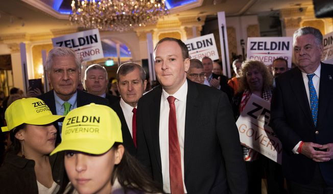 U.S. Rep. Lee Zeldin, center, walks to the stage before speaking to delegates and assembled party officials at the 2022 NYGOP Convention, Tuesday, March 1, 2022, in Garden City, N.Y. Republicans from across New York met Tuesday to choose their gubernatorial nominee to run against Gov. Kathy Hochul in November. The GOP nominated Zeldin, of Long Island, as the party&#x27;s designee for this year&#x27;s gubernatorial race.  (AP Photo/John Minchillo)