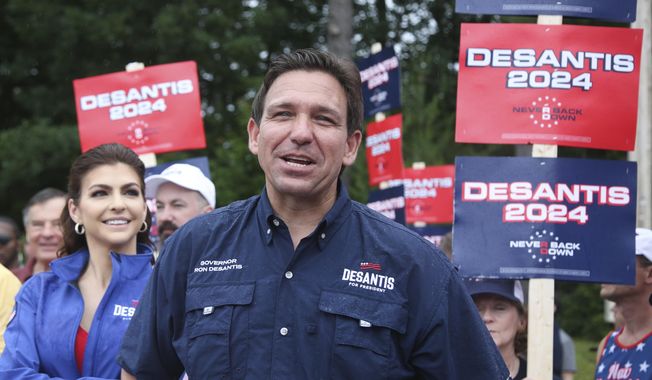 Republican presidential candidate and Florida Gov. Ron DeSantis and his wife Casey, walk in the July 4th parade, July 4, 2023, in Merrimack, N.H. DeSantis is defending an anti-LGBTQ video his campaign shared online that attacks rival Donald Trump for his past support of gay and transgender people, despite some of his fellow Republicans calling it homophobic. (AP Photo/Reba Saldanha, File)