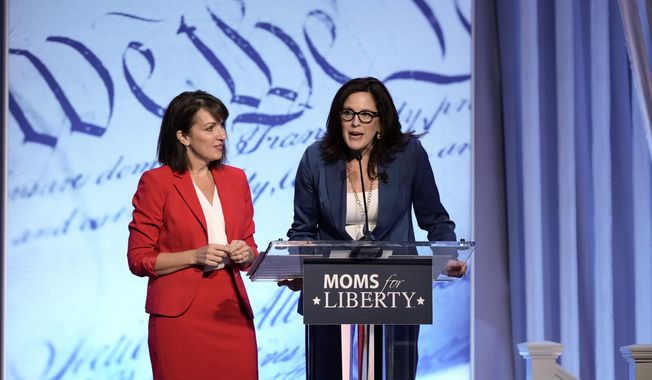 Moms for Liberty founders Tiffany Justice, right, and Tina Descovich speak at the Moms for Liberty meeting in Philadelphia, Friday, June 30, 2023. (AP Photo/Matt Rourke)