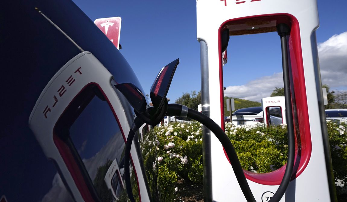 A Tesla auto charges on May 10, 2023, in Westlake, Calif. All of Ford Motor Co.&#x27;s current and future electric vehicles will have access to about 12,000 Tesla Supercharger stations starting in 2024, according to an announcement Thursday, May 25, 2023, by Ford CEO Jim Farley and Tesla CEO Elon Musk. (AP Photo/Mark J. Terrill) **FILE**