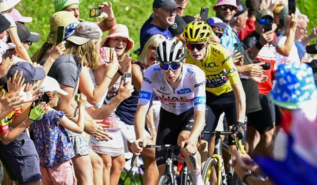Denmark&#x27;s Jonas Vingegaard, wearing the overall leader&#x27;s yellow jersey, and Slovenia&#x27;s Tadej Pogacar, wearing the best young rider&#x27;s white jersey, climb Joux Plane pass during the fourteenth stage of the Tour de France cycling race over 152 kilometers (94.5 miles) with start in Annemasse and finish in Morzine Les Portes du Soleil, France, Saturday, July 15, 2023. (Bernard Papon/Pool Photo via AP)