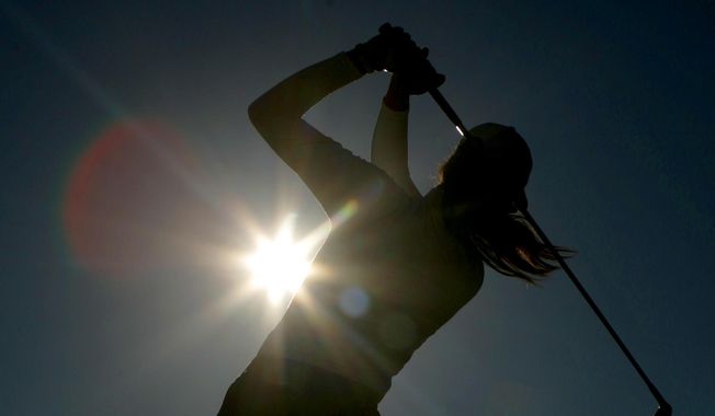 A golfer is silhouetted against the sun while teeing off on the third hole during the first round of the Women&#x27;s British Open golf tournament at Royal Lytham and St Annes golf course in Lytham, north west England Thursday, Aug. 3, 2006. Kerry Bowie&#x27;s daughters have dreams. Big ones. “There are some things people miss out on by not doing it,” Bowie says. “To be that young lady who plays golf, it changes things.” (AP Photo/Matt Dunham, File)