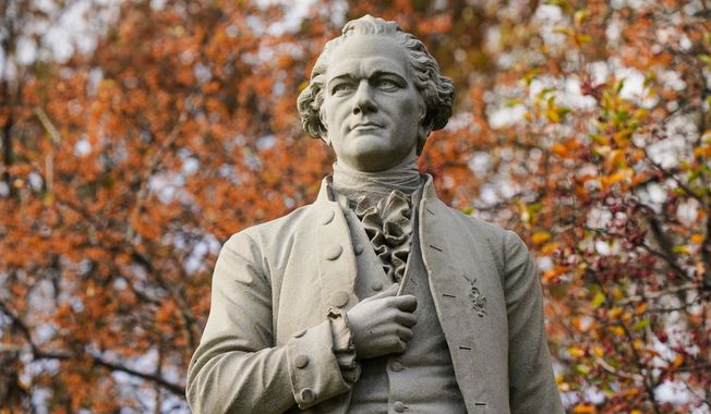 In this Tuesday, Nov. 10, 2020, file photo, a statue of Alexander Hamilton stands in Central Park in New York. A new research paper takes a swipe at the popular image of Alexander Hamilton as the abolitionist founding father, citing evidence that he was a slave trader and owner himself. (AP Photo/Frank Franklin II, File)