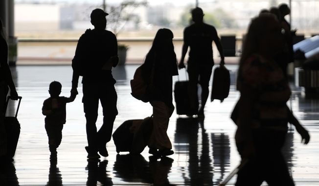 People travel through Salt Lake City International Airport Friday, June 30, 2023, in Salt Lake City. (AP Photo/Rick Bowmer)