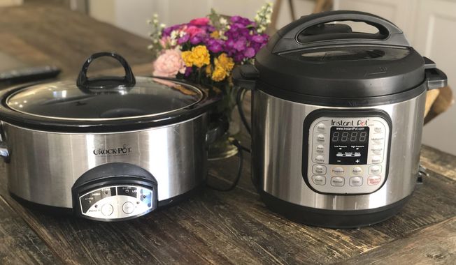This March 18, 2019 photo shows two well loved small appliances, a slow cooker, left, and an Instant Pot, in a New York home. Which appliance you prefer will depend on what you plan to use them for. (Katie Workman via AP)
