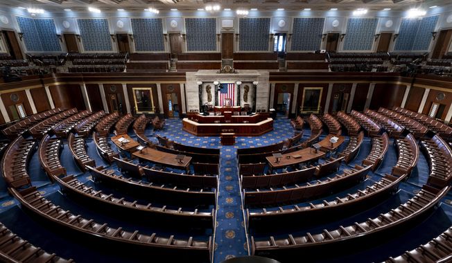 The chamber of the House of Representatives is seen at the Capitol in Washington, Feb. 28, 2022. Just seven Republicans, along with most Democrats, used remote voting in the House when it began two years ago as the pandemic erupted. As of April 2022, over half of GOP lawmakers used the proxy voting system at least once, along with nearly all Democrats. More than 50 of the Republicans who’ve used it this year also once signed onto a lawsuit seeking to declare the practice unconstitutional. (AP Photo/J. Scott Applewhite, File)  **FILE**