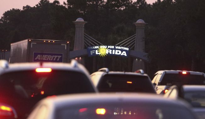 Traffic backs in the north-bound lanes of Interstate 75 near the Georgia-Florida state line as people flee Hurricane Irma Friday, Sept. 8, 2017, in Jennings, Fla. (AP Photo/John Bazemore)