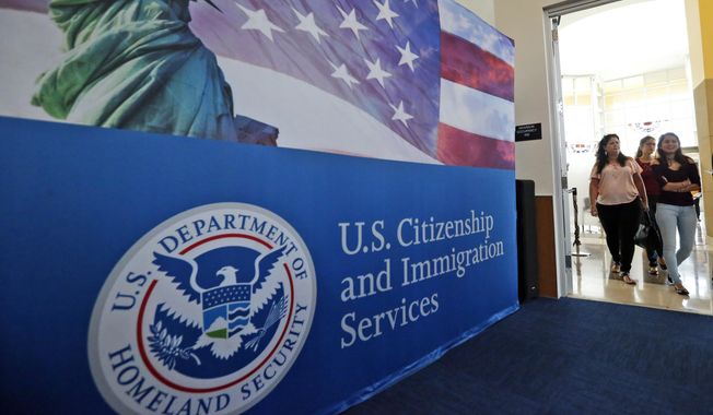 In this Aug. 17, 2018, file photo, people arrive before the start of a naturalization ceremony at the U.S. Citizenship and Immigration Services Miami Field Office in Miami. (AP Photo/Wilfredo Lee, File)