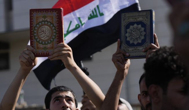Supporters of the Shiite cleric Muqtada al-Sadr raise the Quran, the Muslims&#x27; holy book, during a demonstration in front of the Swedish Embassy in Baghdad, on June 30, 2023, in response to the burning of Quran in Sweden. Protesters angered by the burning of a copy of the Quran stormed the Swedish Embassy in Baghdad early Thursday, July 20, 2023, online videos purported to show. (AP Photo/Hadi Mizban, File)