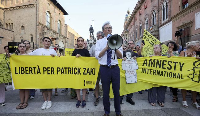 Protesters demonstrate in support of Patrick Zaki by the Piazza del Nettuno, in Bologna, Italy, Tuesday, July 18, 2023. An Egyptian court sentenced Zaki, a rights activist, on Tuesday to three years in prison over an opinion article he wrote in 2019 in a case that renewed global attention to Egypt&#x27;s intolerance of government critics. He was arrested in February 2020 shortly after landing in Cairo on a short trip home from Italy where he was a postgraduate student at the University of Bologna. (Guido Calamosca/LaPresse via AP)