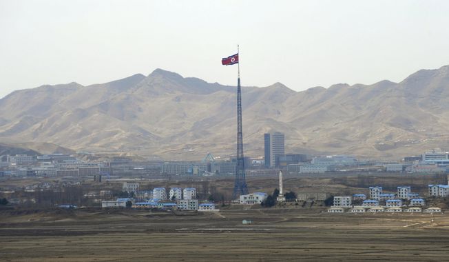 North Korea&#x27;s flag flies on a tower high above the village of Ki Jong Dong, as seen from Observation Post Ouellette in the Demilitarized Zone, DMZ, the tense military border between the two Koreas, in Panmunjom, Korea, March 25, 2012. A series of low-slung buildings and somber soldiers dot the landscape of the DMZ, the swath of land between North and South Korea where a soldier on a tour crossed into North Korea on Tuesday, July 18, 2023, under circumstances that remain unclear. (AP Photo/Susan Walsh, File)