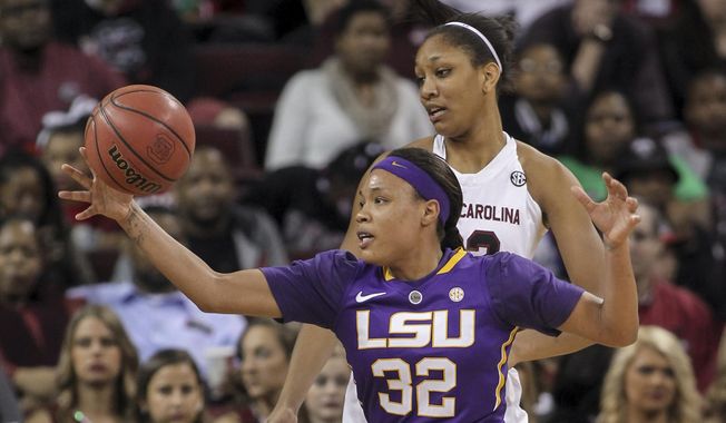 LSU&#x27;s Danielle Ballard (32) chases a loose ball in front of South Carolina&#x27;s A&#x27;ja Wilson during an NCAA college basketball game Feb. 12, 2015, in Columbia, S.C. Ballard has died after she was struck by a car in Memphis, Tenn. Police say the 29-year-old Ballard “succumbed to her injuries” at a hospital after being taken from the scene of an accident that was reported to dispatchers early Thursday. Authorities say the investigation is ongoing and in its preliminary stages. (AP Photo/Travis Bell, File) **FILE**