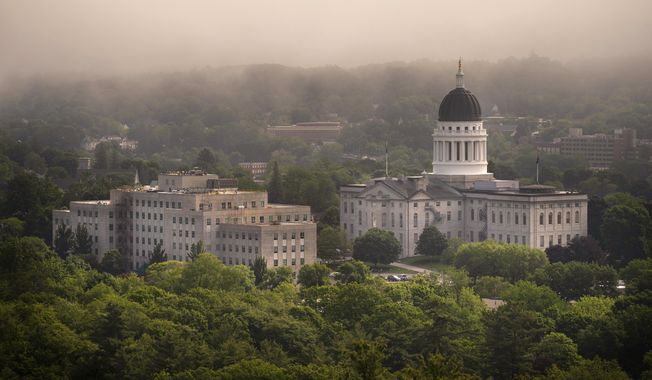 The morning fog lifts beyond the Burton M. Cross Building, left, and the State House, Wednesday, June 21, 2023, in Augusta, Maine. The legislature is working to wrap up the current session. (AP Photo/Robert F. Bukaty)