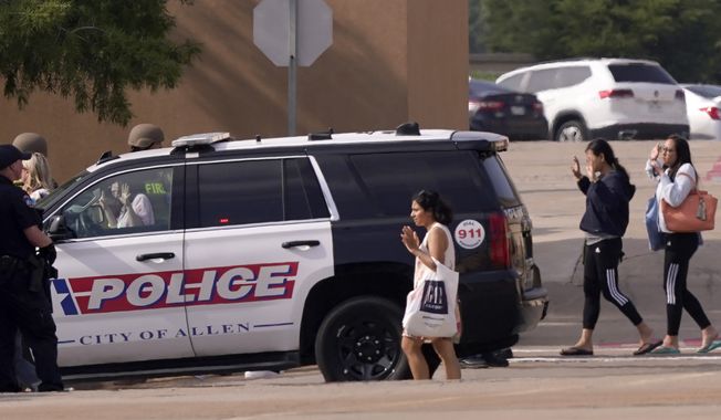 People raise their hands as they leave a shopping center after a shooting on May 6, 2023, in Allen, Texas. Police released video footage Wednesday, June 28, of an officer killing a neo-Nazi gunman, quickly ending a mass shooting that left eight people dead and seven others wounded at the mall. The edited five-and-a-half-minute video details the final moments of Mauricio Garcia, 33, after he unleashed a rain of bullets from an AR-15-style rifle. (AP Photo/LM Otero, File)