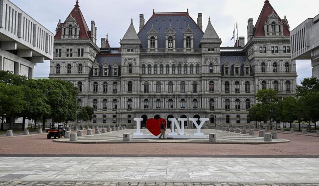 The New York state Capitol is seen as Assembly members return after the regular legislative session ended to work on unfinished business in Albany, N.Y., Tuesday, June 20, 2023. Hospitals and other health care providers in New York would be banned from reporting medical debt to credit reporting agencies under a bill passed this week by the state&#x27;s legislature. (AP Photo/Hans Pennink, File)