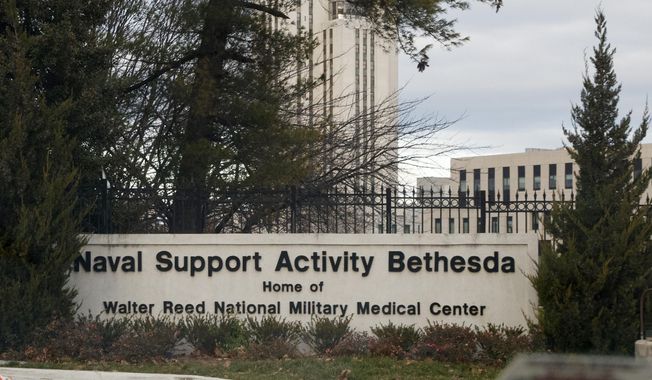 An sign stands near an entrance to Walter Reed National Military Medical Center on Tuesday, Nov. 27, 2018, in Bethesda, Md. The management of the medical center has drawn criticism from a prominent archbishop - and some members of Congress - by choosing not to renew a contract for Franciscan priests to provide pastoral care, and by hiring a hiring a secular defense contractor, Mack Global LLC, to oversee provision of those services going forward. Walter Reed said it notified the Franciscans in March 2023 that their contract would not be renewed. (AP Photo/Carolyn Kaster, File)