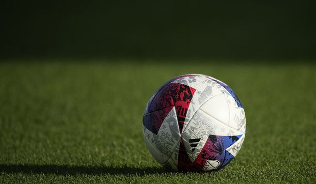 Soccer ball sits on the pitch in the second half of an MLS soccer match Wednesday, July 12, 2023, in Commerce City, Colo. The first half of the match was played Tuesday, July 4, before it was delayed by a rainstorm and rescheduled for Wednesday. (AP Photo/David Zalubowski)