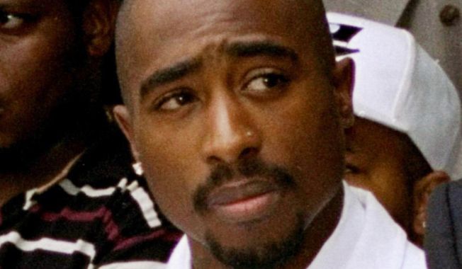 Rapper Tupac Shakur attends a voter registration event in South Central Los Angeles on Aug. 15, 1996.  Shakur’s handwritten lyrics from classic songs such as “California Love” and “Dear Momma” along galleries that pay homage to his upbringing and mother are among the artifacts featured in a massive touring museum exhibit. The Shakur Estate announced Tuesday, Nov. 2, 2021, that the “Tupac Shakur. Wake Me When I’m Free” will open on Jan. 21, 2022, in Los Angeles. (AP Photo/Frank Wiese) **FILE**