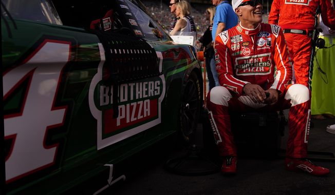 Kevin Harvick (4) sits beside his car before a NASCAR Cup Series auto race at Atlanta Motor Speedway on Sunday, July 9, 2023, in Hampton, Ga. (AP Photo/Brynn Anderson)