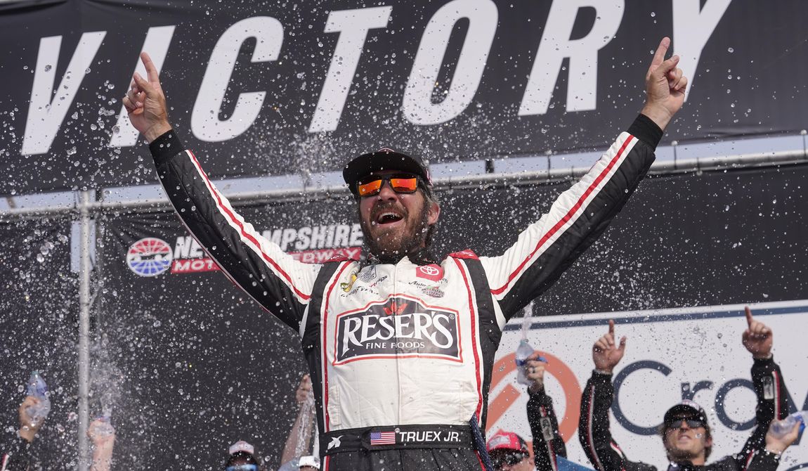 Martin Truex Jr., celebrates his win in the Crayon 301 NASCAR Cup Series auto race, Monday, July 17, 2023, at New Hampshire Motor Speedway, in Loudon, N.H. (AP Photo/Steven Senne)