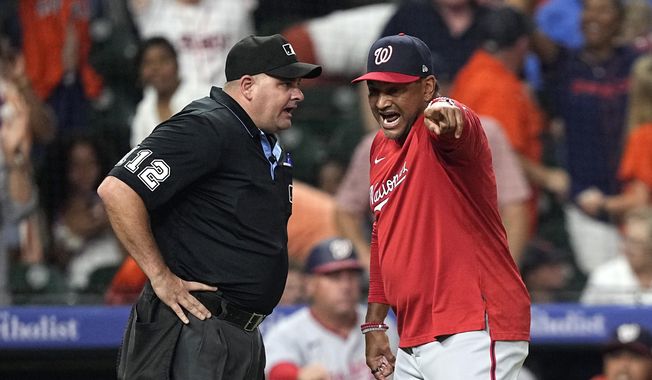 Washington Nationals manager Dave Martinez, right, argues with home plate umpire Jeremy Riggs after the final play during the ninth inning of a baseball game against the Houston Astros Wednesday, June 14, 2023, in Houston. The Astros won 5-4. (AP Photo/David J. Phillip)