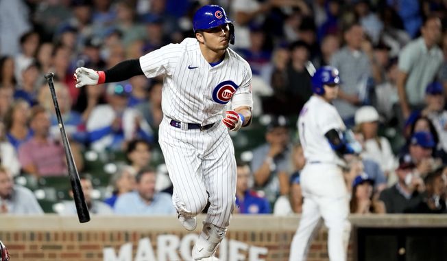 Chicago Cubs&#x27; Seiya Suzuki watches his RBI single off Washington Nationals relief pitcher Amos Willingham in the seventh inning of a baseball game Tuesday, July 18, 2023, in Chicago. (AP Photo/Charles Rex Arbogast)