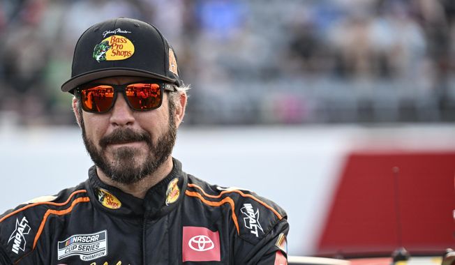 Martin Truex Jr. looks on prior to the NASCAR All-Star Cup Series auto race at North Wilkesboro Speedway, Sunday, May 21, 2023, in North Wilkesboro, N.C. The 43-year-old Martin Truex Jr. has yet to make a decision -- at least, publicly -- on if he’ll return for another season at Joe Gibbs Racing or hang up the helmet and end a career that included the 2017 NASCAR championship.(AP Photo/Matt Kelley, File) **FILE**
