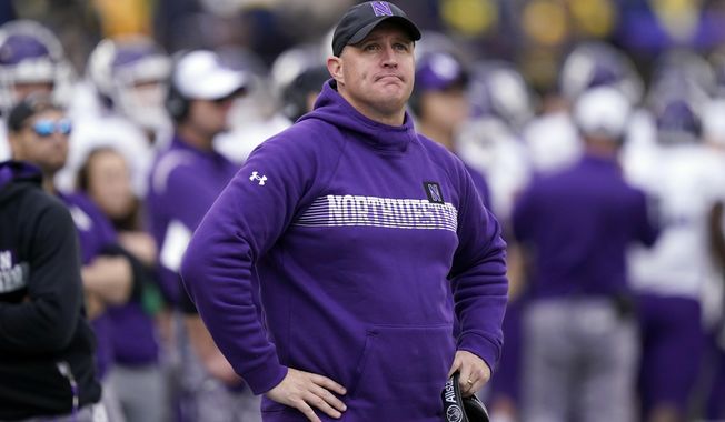 Northwestern head coach Pat Fitzgerald stands on the sideline during the first half of an NCAA college football game against Michigan, Oct. 23, 2021, in Ann Arbor, Mich. Northwestern has fired Fitzgerald Monday, July 10, 2023, amid a hazing scandal that called into question his leadership of the program and damaged the university&#x27;s reputation after it mishandled its response to the allegations. (AP Photo/Carlos Osorio, File)