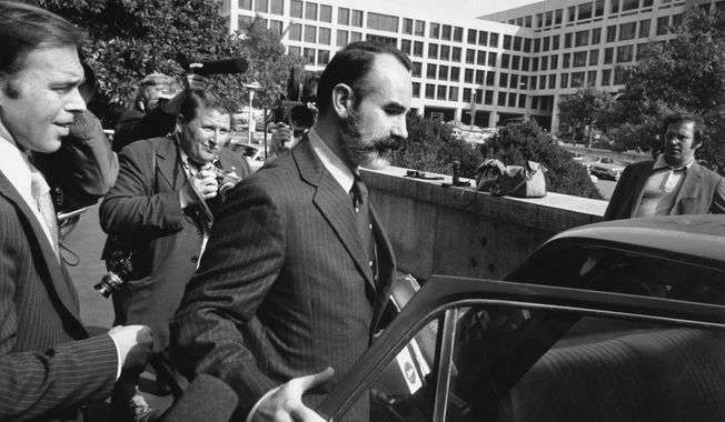 In this Oct. 15, 1974, file photo, G. Gordon Liddy wears a beard and a mustache upon his release in Washington. Liddy posted a $5,000 bond after serving 21 months in jail. Liddy, a mastermind of the Watergate burglary and a radio talk show host after emerging from prison, has died at age 90. His son, Thomas Liddy, confirmed the death Tuesday, March 30, 2021, but did not reveal the cause. (AP Photo/File)