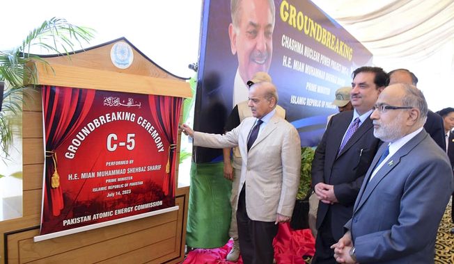 In this photo released by Press Information Department, Pakistan&#x27;s Prime Minister Shehbaz Sharif, center, unveils plaque during the groundbreaking ceremony of 5th Unit of Chashma Nuclear Power Plant (Chashma-5) in Chashma, Mianwali, Pakistan, Friday, July 14, 2023. Sharif launched the construction of a 1,200-megawatt Chinese-designed nuclear energy project, which will be built at a cost of $3.5 billion as part of the government efforts to generate more clean energy in the Islamic nation. (Press Information Department via AP)